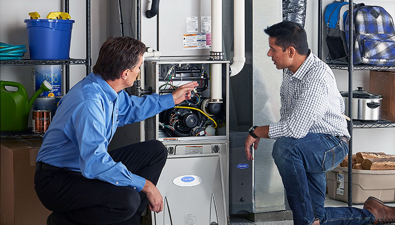HVAC technician evaluating a furnace for repair or replacement in El Mirage