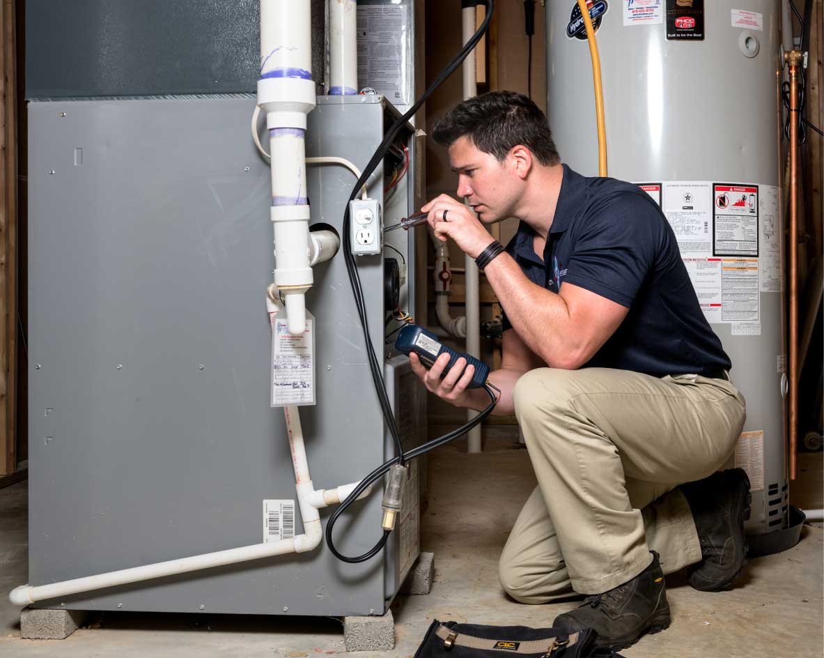 HVAC technician performing a furnace tune-up in El Mirage