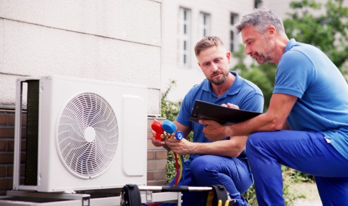 HVAC technicians installing an outdoor air conditioning unit in El Mirage