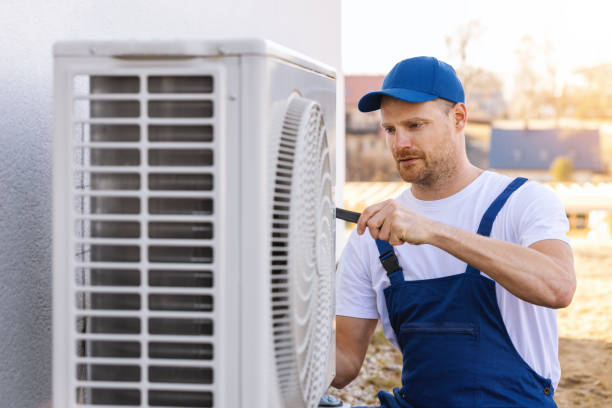 HVAC technician servicing an outdoor air conditioning unit in El Mirage