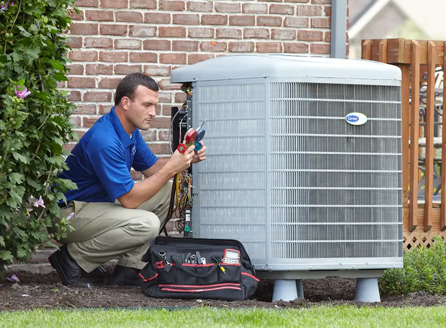 HVAC technician inspecting an outdoor air conditioning unit in El Mirage