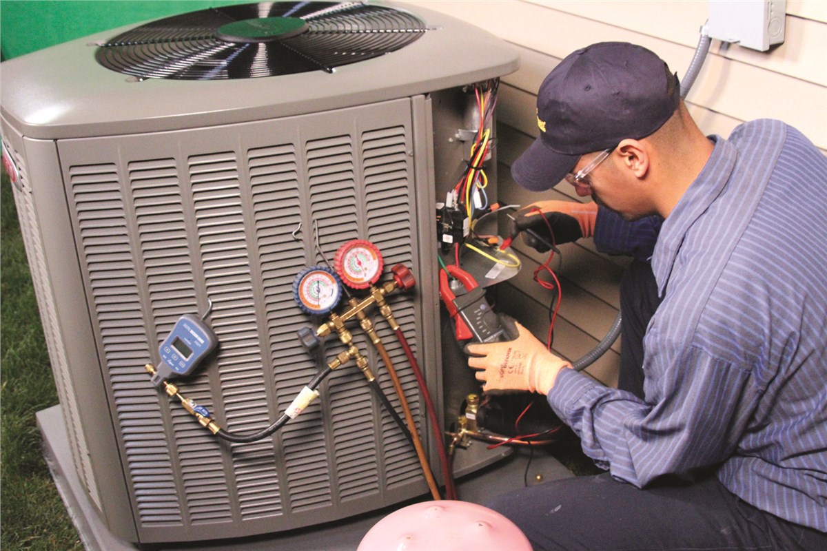 HVAC technician testing an outdoor air conditioning unit in El Mirage